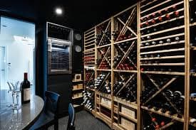 Luxury custom wine cellar installation in Charlotte, NC - climate-controlled wine storage with premium racking and glass enclosures