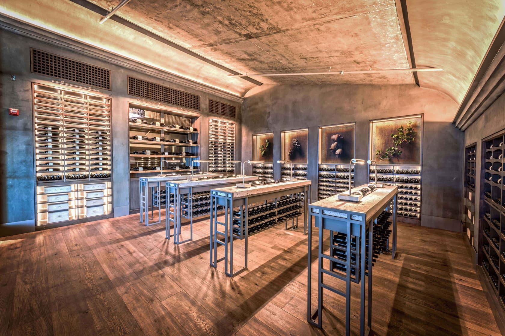 Commercial wine room in Uptown Charlotte featuring modern metal racking and glass display cases